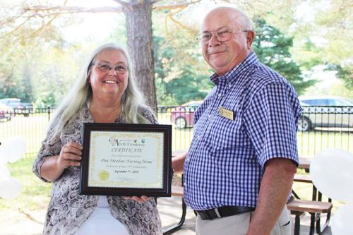 North Frontenac Coun. Gerry Martin presented Pine Meadow administrator Margaret Palimaka with a certificate from the Township acknowledging the 25th anniversary. Photo/Craig Bakay